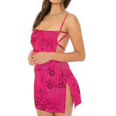 Model displaying an open back sequin embroidered mini dress with spaghetti straps and a square collar.